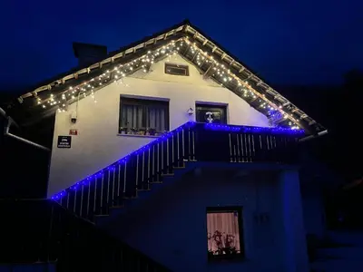 a house with christmas lights on the roof at Apartma Anastasija in Kranjska Gora