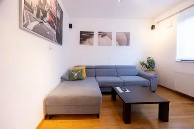 a living room with a blue couch and a coffee table at Apartmaji Anže Kranjska Gora in Kranjska Gora