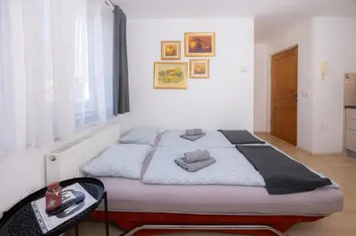 a bedroom with a bed with two pillows on it at Apartmaji Anže Kranjska Gora in Kranjska Gora