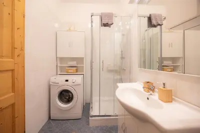 a bathroom with a washing machine and a washer at Apartmaji Anže Kranjska Gora in Kranjska Gora