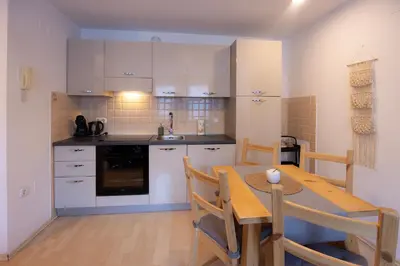 a kitchen with a table and a dining room at Apartmaji Anže Kranjska Gora in Kranjska Gora