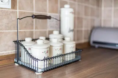 a group of white candles in a holder on a counter at Hiša nasproti sonca in Kranjska Gora