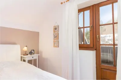 a bedroom with a bed and a window at Hiša nasproti sonca in Kranjska Gora