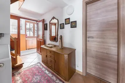 a room with a mirror and a wooden door at Hiša nasproti sonca in Kranjska Gora