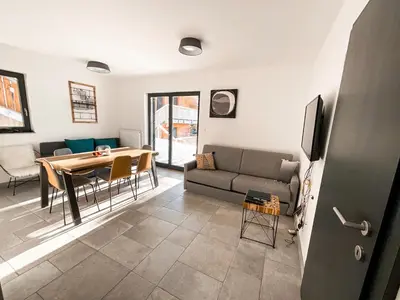 a living room with a couch and a table at Sunshine Apartments Golte COMFORT in Mozirje
