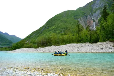 a group of people in a boat in the water at SočaLand Apartmaji in Soča