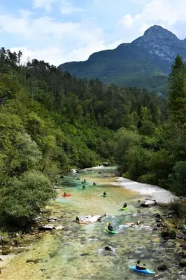 a group of people swimming in a river at SočaLand Apartmaji in Soča