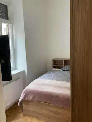 a small bedroom with a bed and a window at Tiny Twix room in the City centre in Ljubljana