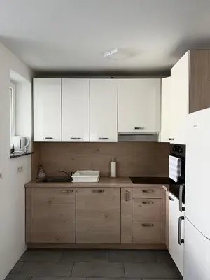 a kitchen with white cabinets and a sink at Perfect Place Apartments in Kranj