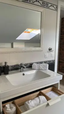 a bathroom with a sink and a mirror at All Seasons Apartments Laško in Laško