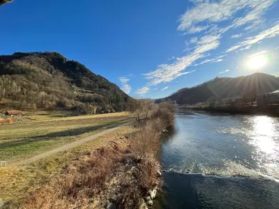a view of a river with the sun in the sky at All Seasons Apartments Laško in Laško