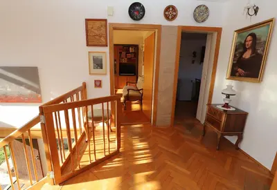 a living room with a staircase and a stair case at Vintage Apartment Bled in Bled