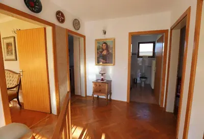 a room with a hallway with a table and a door at Vintage Apartment Bled in Bled