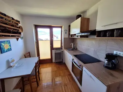a kitchen with a table and a counter top at Vintage Apartment Bled in Bled