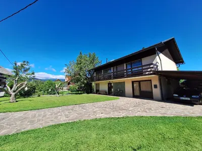 a large house with a lawn in front of it at Vintage Apartment Bled in Bled