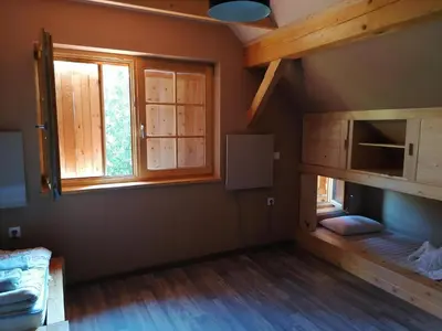 a room with a bunk bed and a window at Cottage Golenovo in Podvelka