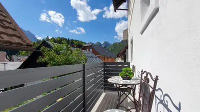 a balcony with a table and a fence at Apartments Seventy Seven in Kranjska Gora