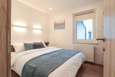 a bedroom with a large bed and a window at Apartments Seventy Seven in Kranjska Gora
