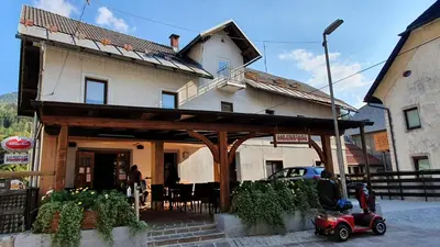 a small red car parked in front of a house at Apartments Seventy Seven in Kranjska Gora