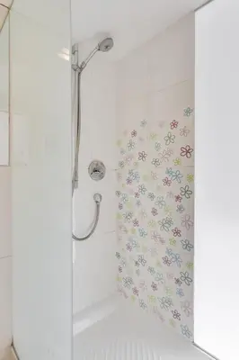 a shower with a floral shower curtain in a bathroom at Fine Ljubljana Apartments in Ljubljana
