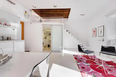 a white living room with a white table and chairs at Fine Ljubljana Apartments in Ljubljana