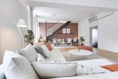 a living room with a white couch and a table at Fine Ljubljana Apartments in Ljubljana