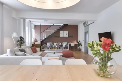 a living room with a vase of flowers on a table at Fine Ljubljana Apartments in Ljubljana