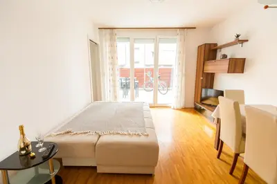 a bedroom with a large bed and a table at Apartment Lakeside Cerknica in Cerknica