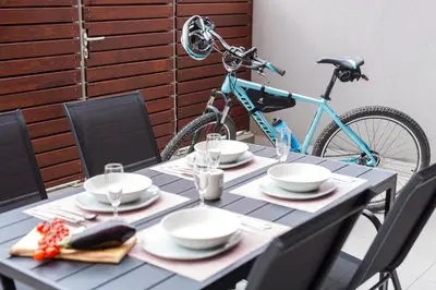 a table with plates and a bike parked next to it at Apartment Lakeside Cerknica in Cerknica