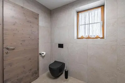 a bathroom with a toilet and a window at Domačija Vrški in Slovenska Bistrica