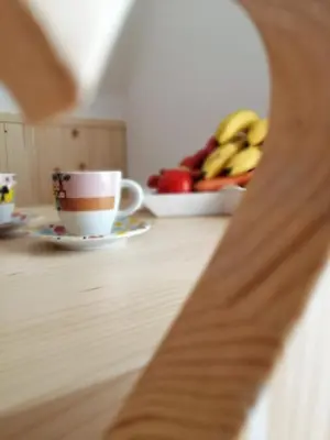 a table with a cup of coffee and a plate of fruit at Alpine Spirit - Family Apartment in Kranjska Gora