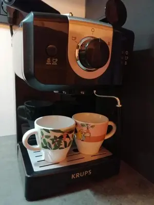 a coffee maker with two cups on a stand at Alpine Spirit - Family Apartment in Kranjska Gora