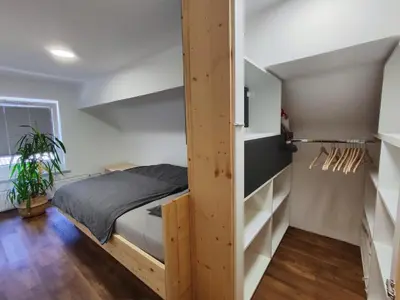 a bedroom with a bed and a book shelf at Alpine Spirit - Family Apartment in Kranjska Gora