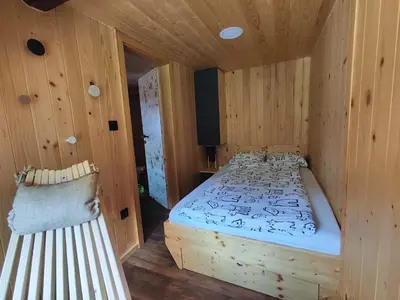 a bedroom with a wooden bed in a room at Alpine Spirit - Family Apartment in Kranjska Gora