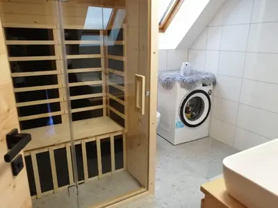 a bathroom with a washer and a washing machine at Alpine Spirit - Family Apartment in Kranjska Gora