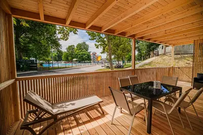a screened in porch with a table and chairs at Premium Mobile Homes with Thermal Riviera Tickets in Čatež ob Savi