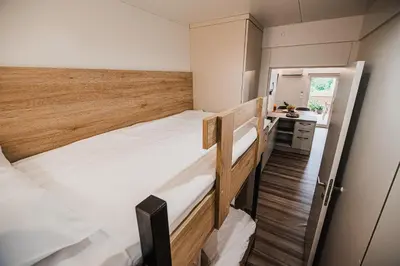 two bunk beds in a small room with a sink at Premium Mobile Homes with Thermal Riviera Tickets in Čatež ob Savi