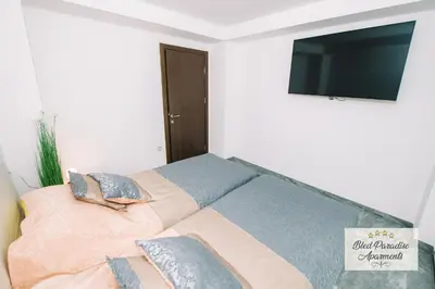 a bedroom with a bed with a flat screen tv at Wellness Paradise Apartment in Bled