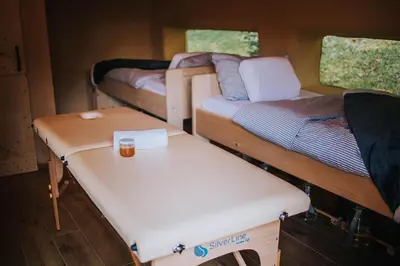 a room with two bunk beds and a table at Sleeping with bees - Tourist farm Muha in Grosuplje