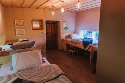 a room with two beds and a desk in it at Sleeping with bees - Tourist farm Muha in Grosuplje