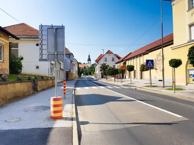 an empty street with a sign in the middle at Fado Apartments Gornja Radgona in Gornja Radgona