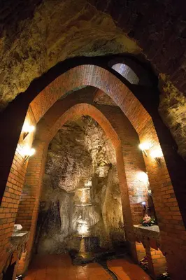 an archway in a cave with a stone wall at Fado Apartments Gornja Radgona in Gornja Radgona