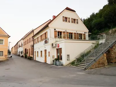 a white building with a staircase in front of it at Fado Apartments Gornja Radgona in Gornja Radgona