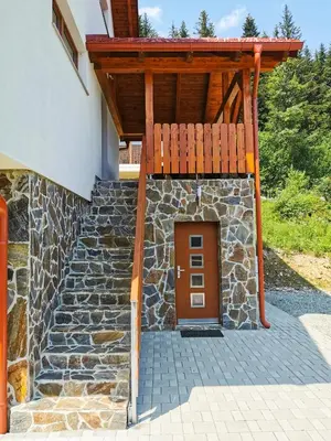 a entrance to a building with a wooden door at APARTMA NIKA in Ribnica na Pohorju
