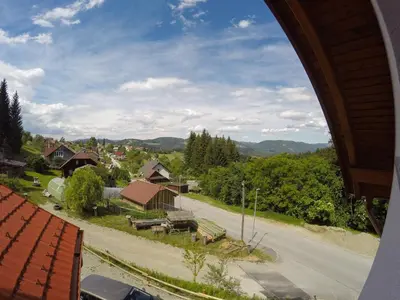 a view from a window of a road and houses at APARTMA NIKA in Ribnica na Pohorju