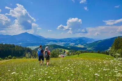 a man and a woman standing in a field of flowers at APARTMA NIKA in Ribnica na Pohorju