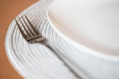 a fork sitting on top of a white plate at Apartma Vila Golf in Rogaška Slatina