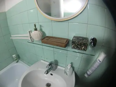 a bathroom with a sink and a mirror at Road View Apartment Celeia in Celje