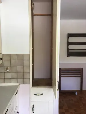 a kitchen with a sink and a cabinet with a mirror at Road View Apartment Celeia in Celje