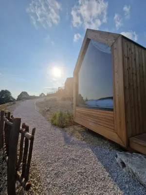 a wooden bed on the side of a road at GoLife Center Glamping in Laze v Tuhinju